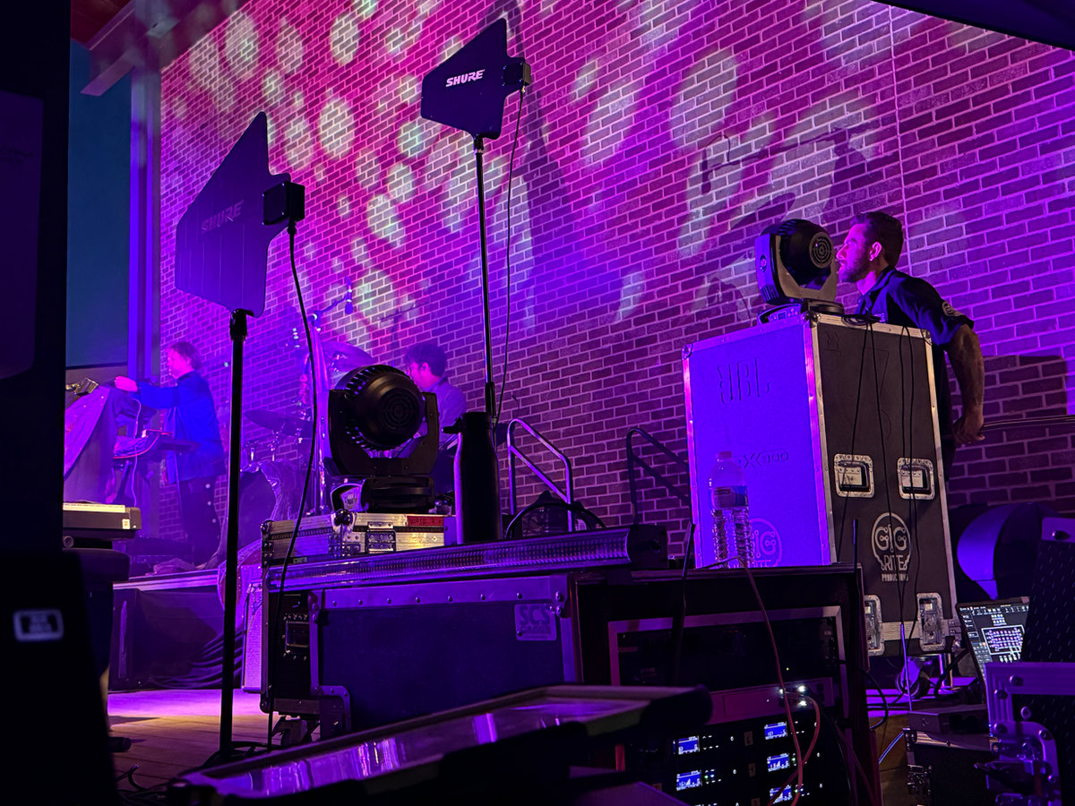 Stage lighting rig with color wash at a brick-walled Atlanta venue