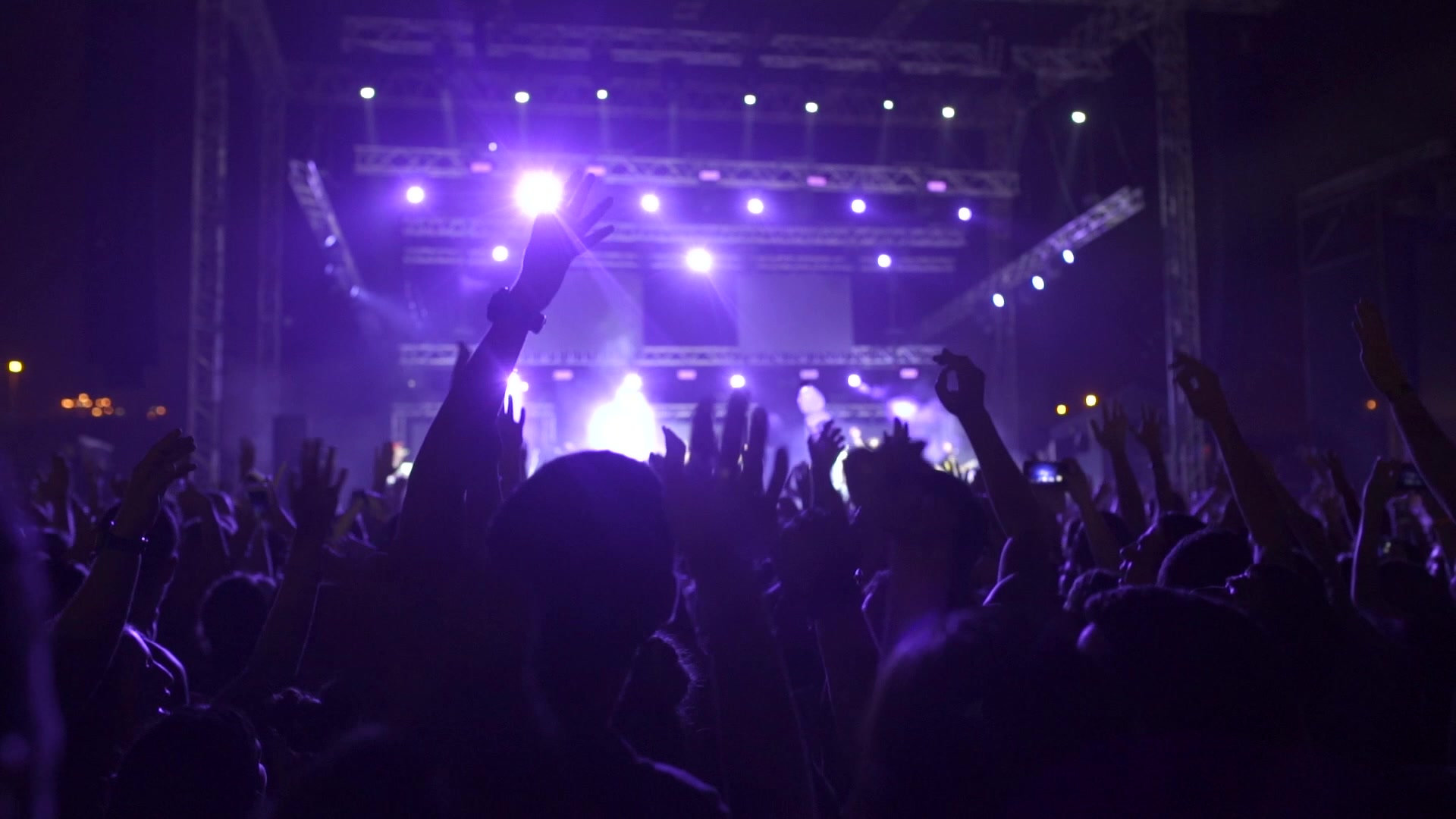 Concert crowd under purple stage lighting at an Atlanta live event produced by GigRite